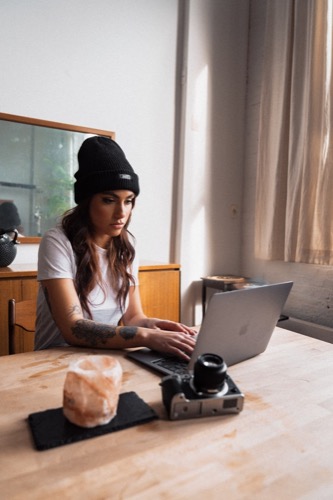 girl in hat on computer